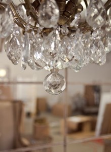 We love combining traditional crystal chandeliers, like this one hanging at our Huff Harrington Home store ...