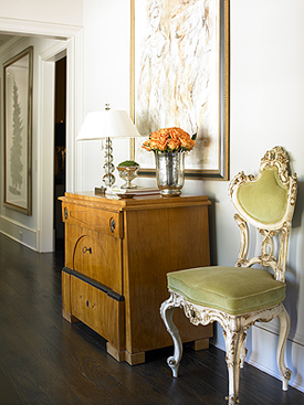 An elegant chest, a wildly carved antique chair and a great abstract painting to pull it all together: that's le mix. From Amy D. Morris.