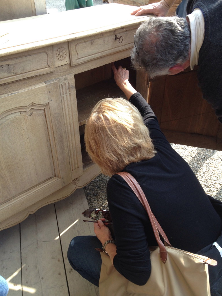 Ann inspecting the inside of a nice 19th century painted buffet.