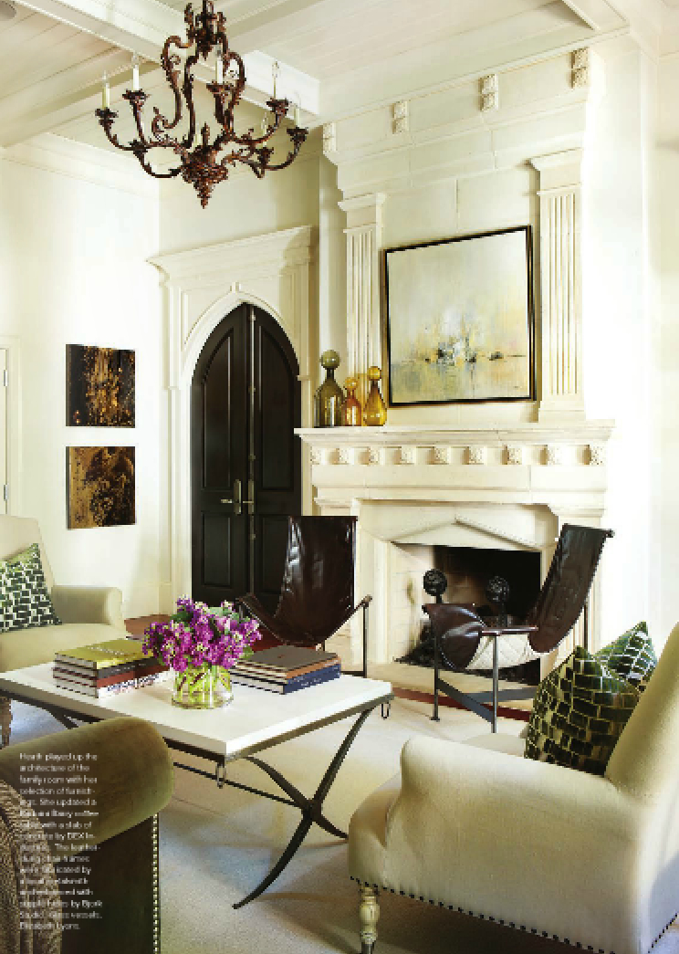 The family room is oozing with personality from the strong iron coffee table to the arched, black door.  Paintings are by Aaron Whitehouse and Pascal Bouterin.