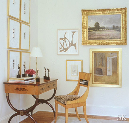 Any one of these paintings would have been lost on the wall but adding similarly-sized work fills the space perfectly.