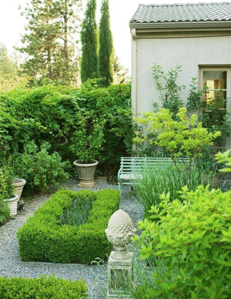 Boxwoods, pea gravel and a perfect bench. It doesn't get any better. Better Homes and Gardens.