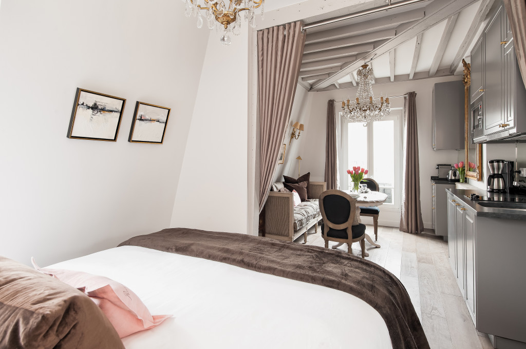 We moved the bedroom to where the kitchen used to be in our Paris small space renovation to keep it more open.
