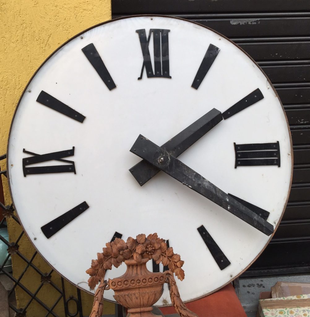 An old church clock, hiding amidst the fray.